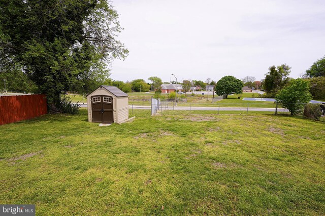 435 N St, Milford, DE 19963 - view of yard with fence, an outbuilding, and a storage shed