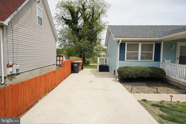 435 N St, Milford, DE 19963 - view of side of property with fence, a shingled roof, and concrete driveway