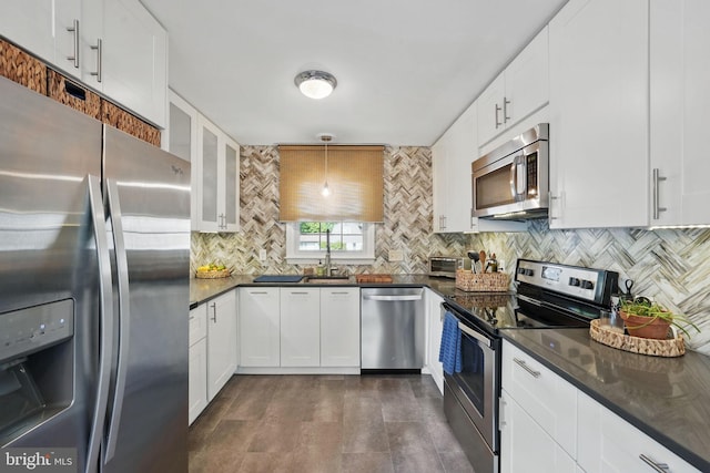 13003 Standish Ct, Woodbridge, VA 22192 - kitchen featuring stainless steel appliances, decorative backsplash, white cabinetry, glass insert cabinets, and a sink