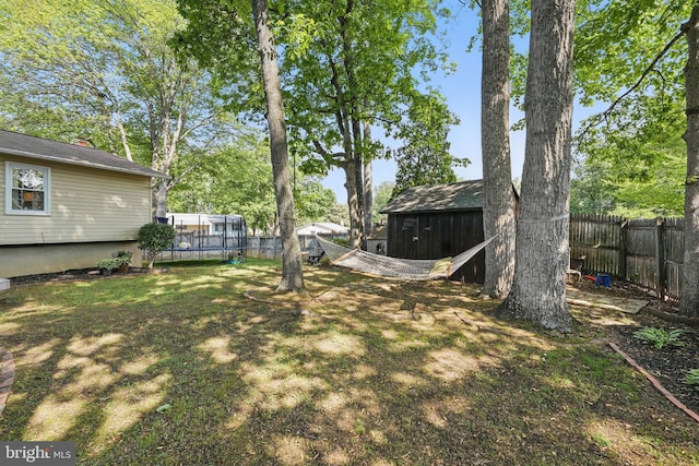 13003 Standish Ct, Woodbridge, VA 22192 - view of yard featuring a trampoline, an outbuilding, and a shed