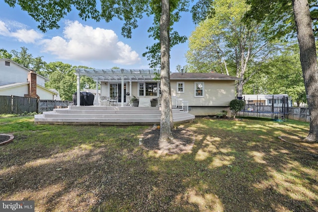 13003 Standish Ct, Woodbridge, VA 22192 - back of house featuring a trampoline, a pergola, and a deck