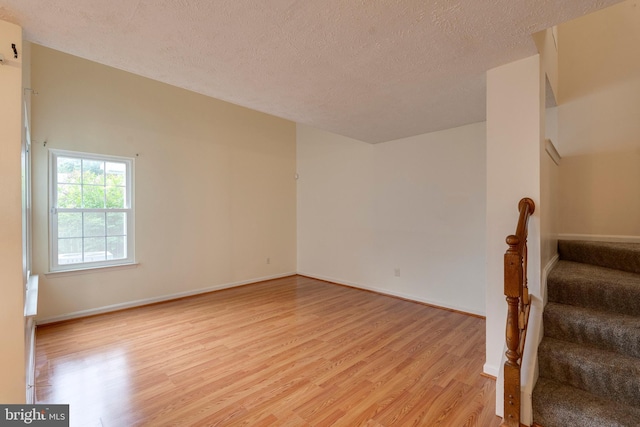 13830 Lord Fairfax Pl, Upper Marlboro, MD 20772 - empty room featuring light wood finished floors, stairs, a textured ceiling, and baseboards