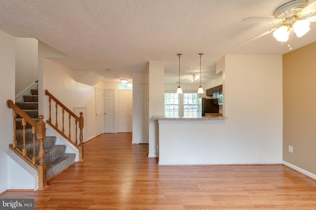 13830 Lord Fairfax Pl, Upper Marlboro, MD 20772 - kitchen with light wood-style floors, a textured ceiling, ceiling fan, freestanding refrigerator, and baseboards