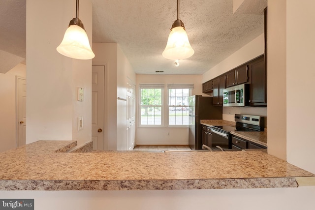 13830 Lord Fairfax Pl, Upper Marlboro, MD 20772 - kitchen with appliances with stainless steel finishes, dark brown cabinetry, light countertops, a textured ceiling, and pendant lighting