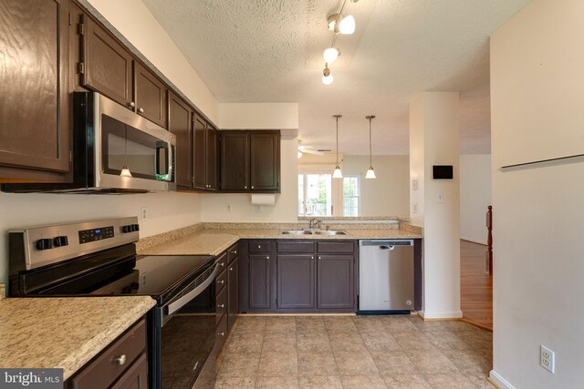 13830 Lord Fairfax Pl, Upper Marlboro, MD 20772 - kitchen with appliances with stainless steel finishes, a sink, dark brown cabinetry, light countertops, and a textured ceiling