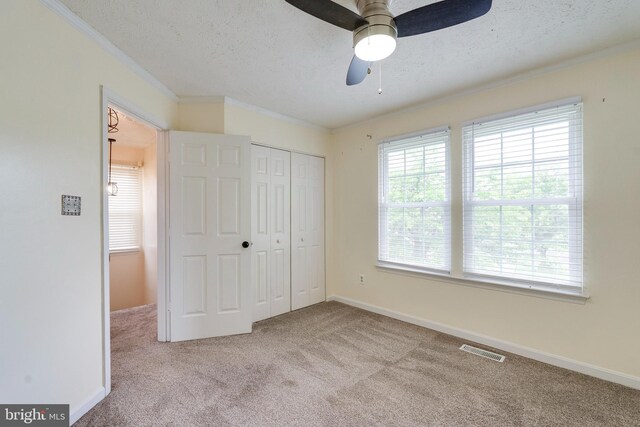 13830 Lord Fairfax Pl, Upper Marlboro, MD 20772 - unfurnished bedroom with carpet flooring, crown molding, a closet, a textured ceiling, and baseboards