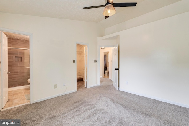 13830 Lord Fairfax Pl, Upper Marlboro, MD 20772 - unfurnished bedroom with carpet flooring, a spacious closet, vaulted ceiling, and baseboards