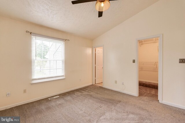 13830 Lord Fairfax Pl, Upper Marlboro, MD 20772 - unfurnished bedroom with vaulted ceiling, a walk in closet, carpet floors, a textured ceiling, and baseboards
