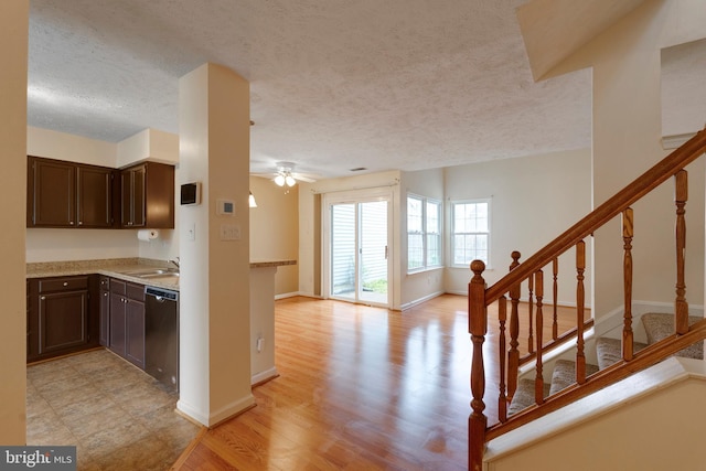 13830 Lord Fairfax Pl, Upper Marlboro, MD 20772 - kitchen featuring stainless steel dishwasher, dark brown cabinets, a textured ceiling, a ceiling fan, and light wood-style flooring