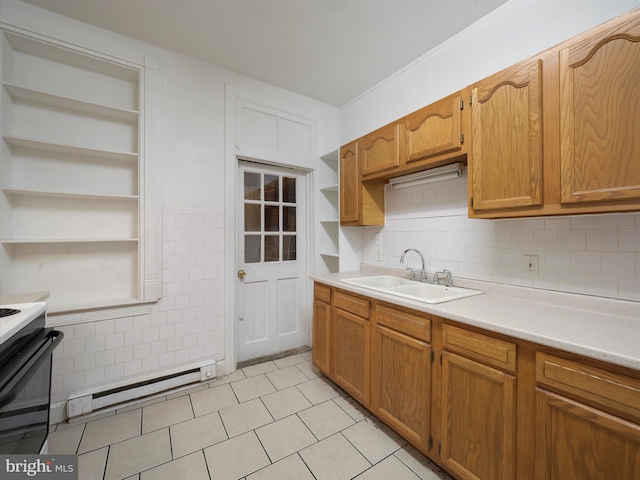 kitchen featuring tile walls, a baseboard radiator, a sink, open shelves, and light countertops