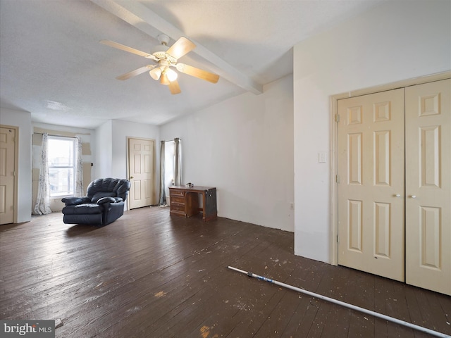 living area featuring wood-type flooring and a ceiling fan