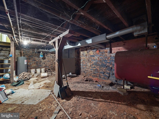 unfinished basement with electric water heater and heating fuel
