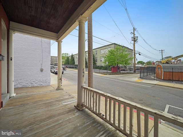 deck with a porch, a gate, and fence
