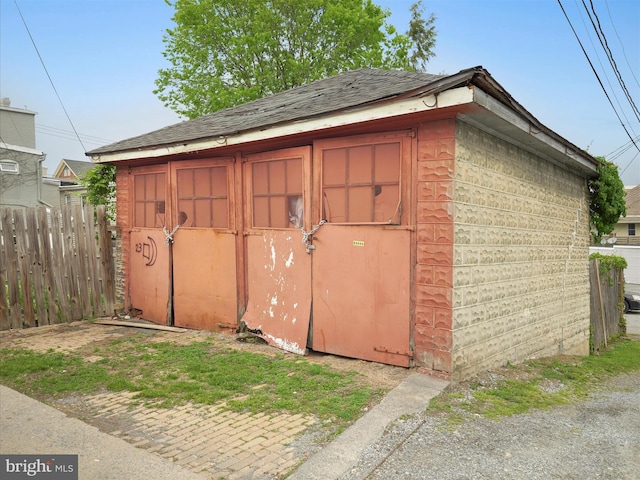 view of shed featuring fence