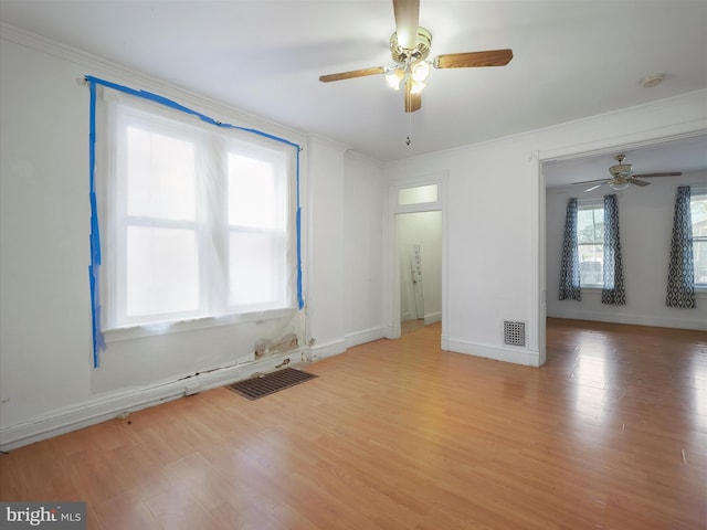 unfurnished room with ceiling fan, visible vents, and light wood-style floors