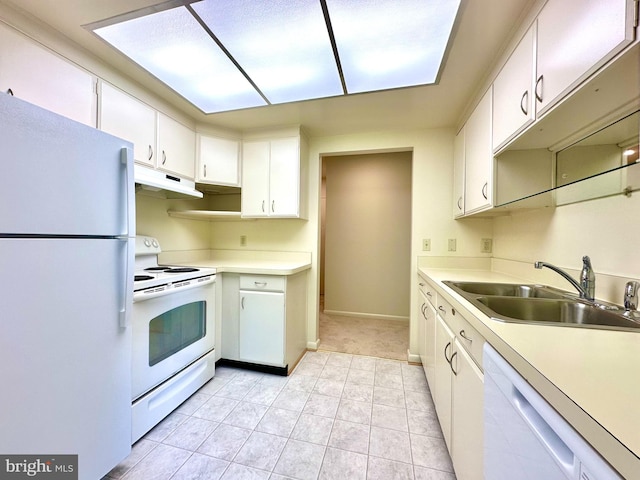kitchen featuring a sink, under cabinet range hood, white cabinets, and white appliances
