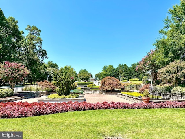 view of home's community featuring fence and a yard