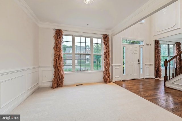 12405 Hillantrae Dr, Clinton, MD 20735 - entryway featuring plenty of natural light, stairs, crown molding, a decorative wall, and wood finished floors