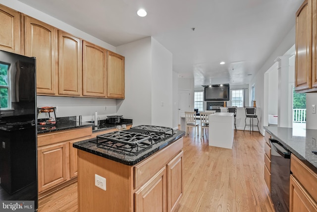 12405 Hillantrae Dr, Clinton, MD 20735 - kitchen featuring black appliances, light wood-style flooring, dark stone counters, a kitchen island, and recessed lighting
