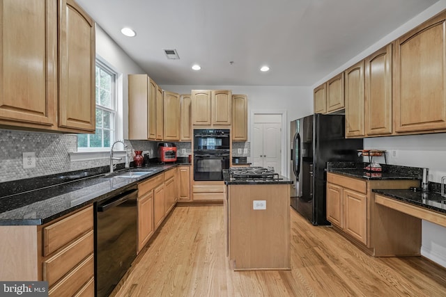 12405 Hillantrae Dr, Clinton, MD 20735 - kitchen featuring black appliances, a sink, light wood-type flooring, a center island, and dark stone counters