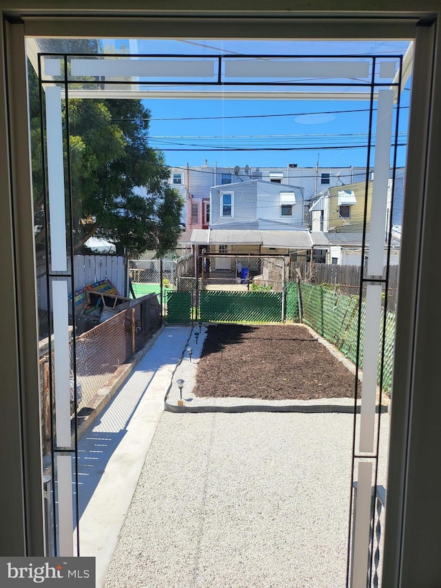 view of patio / terrace with fence and a residential view