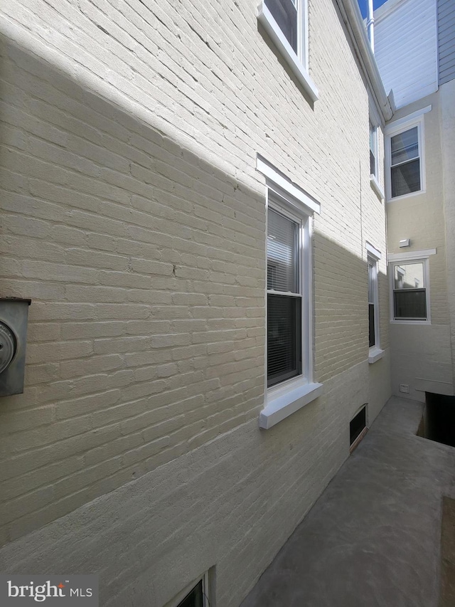 view of side of home with brick siding