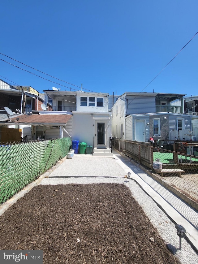 back of property featuring a patio area and fence