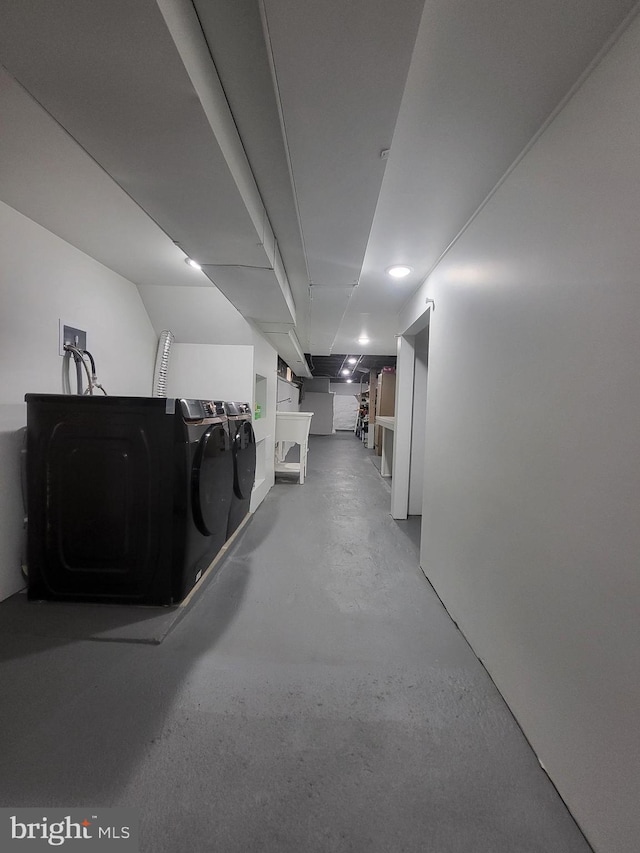 clothes washing area featuring washer and clothes dryer