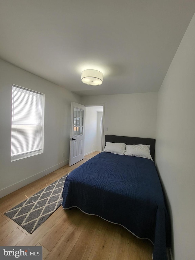 bedroom with baseboards and wood finished floors