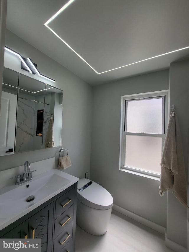 bathroom with toilet and vanity