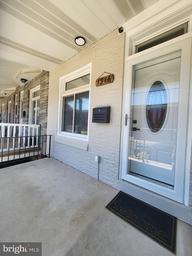 doorway to property featuring covered porch