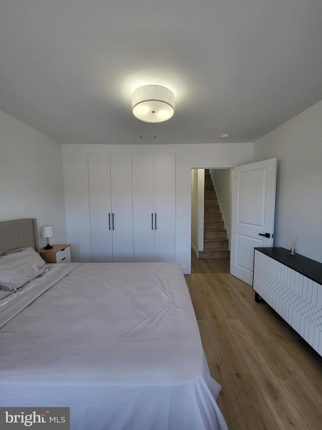 bedroom with a closet and wood finished floors