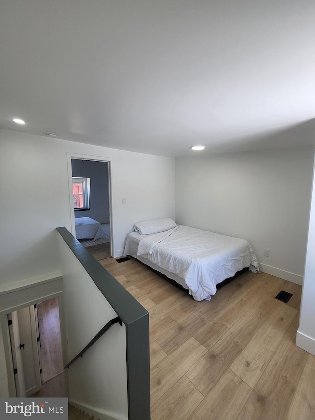 bedroom featuring recessed lighting, baseboards, visible vents, and light wood finished floors