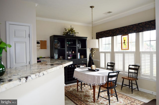 dining area featuring crown molding, visible vents, and baseboards