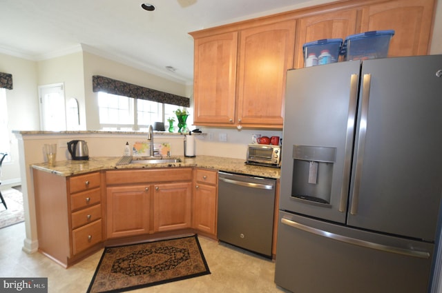 kitchen featuring light stone counters, stainless steel appliances, crown molding, and a sink