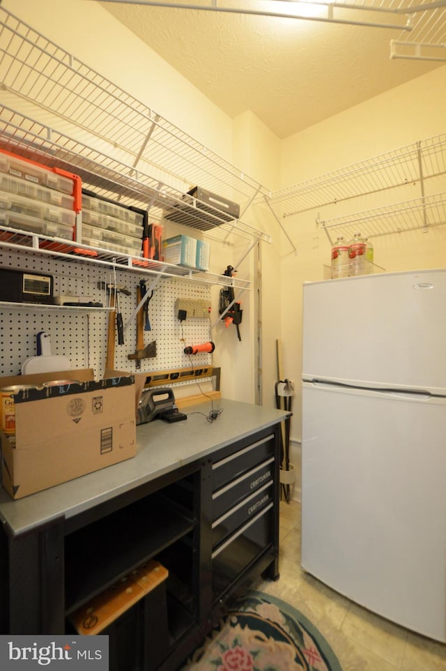 interior space with light tile patterned flooring and a workshop area