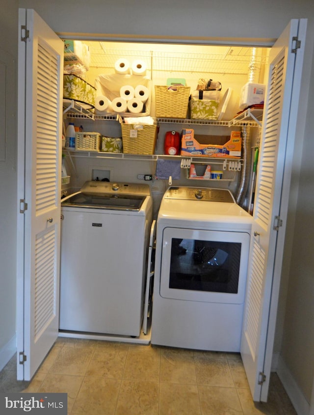 laundry area with laundry area, baseboards, and washer and dryer
