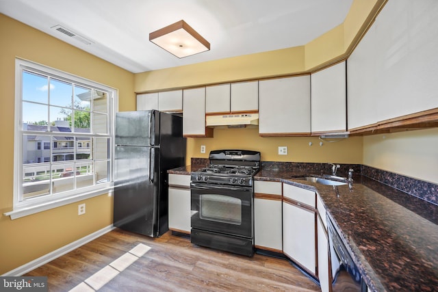 230 Mill Run Ct, Hightstown, NJ 08520 - kitchen with a sink, white cabinetry, under cabinet range hood, visible vents, and black appliances