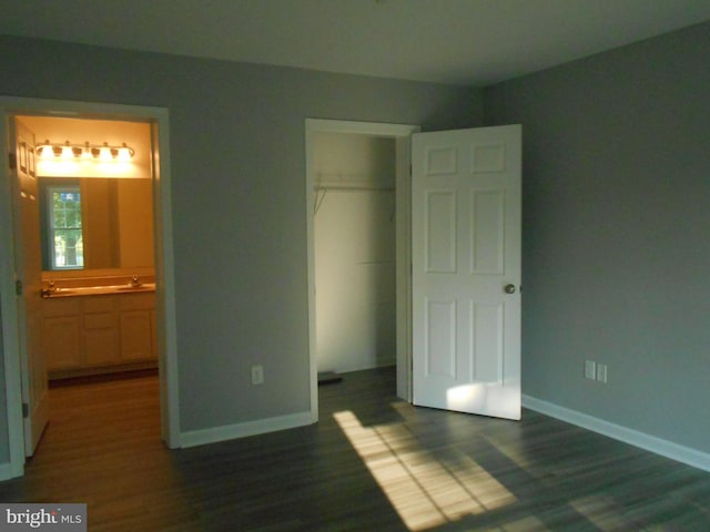 6271 Solomons Cir, Hurlock, MD 21643 - unfurnished bedroom featuring dark wood-style floors, a closet, and baseboards