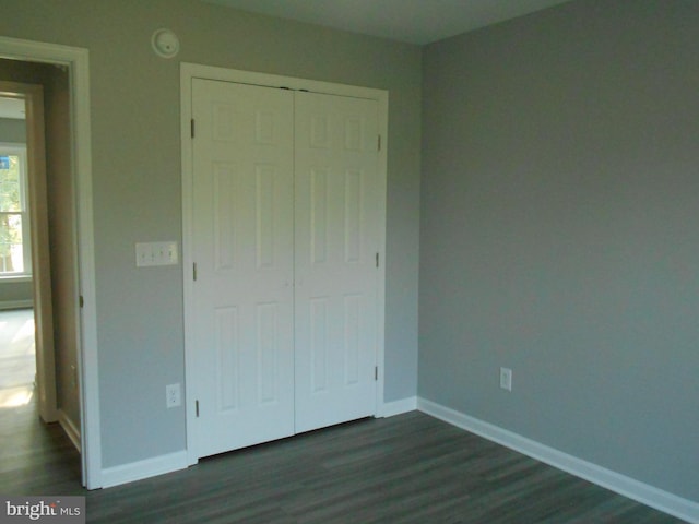6271 Solomons Cir, Hurlock, MD 21643 - unfurnished bedroom featuring dark wood-type flooring, baseboards, and a closet
