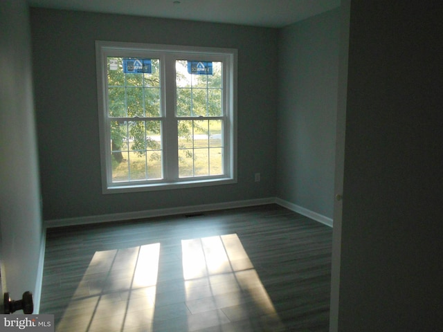 6271 Solomons Cir, Hurlock, MD 21643 - empty room featuring healthy amount of natural light, baseboards, and wood finished floors