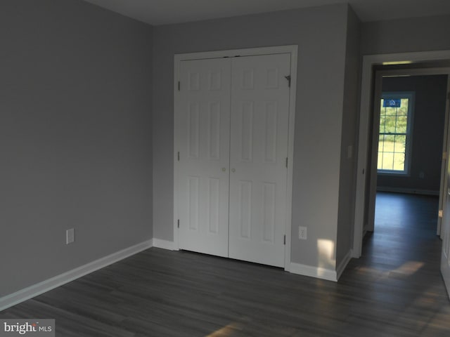 6271 Solomons Cir, Hurlock, MD 21643 - unfurnished bedroom with dark wood finished floors, baseboards, and a closet