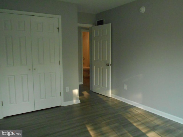 6271 Solomons Cir, Hurlock, MD 21643 - unfurnished bedroom with baseboards, dark wood-style flooring, and a closet