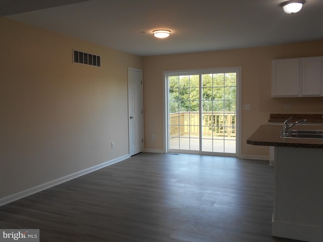 6271 Solomons Cir, Hurlock, MD 21643 - unfurnished dining area with a sink, baseboards, and dark wood-style flooring