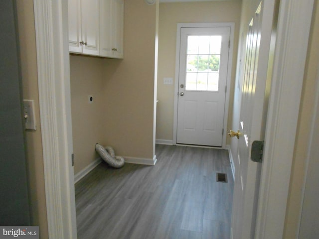 6271 Solomons Cir, Hurlock, MD 21643 - laundry area featuring hookup for an electric dryer, cabinet space, baseboards, and wood finished floors