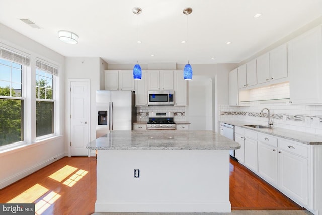 130 Chevy Chase St Unit 404, Gaithersburg, MD 20878 - kitchen featuring a sink, stainless steel appliances, tasteful backsplash, white cabinets, and recessed lighting