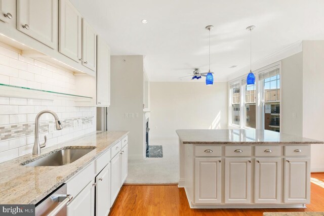 130 Chevy Chase St Unit 404, Gaithersburg, MD 20878 - kitchen with a sink, light wood-type flooring, a center island, white cabinets, and decorative backsplash