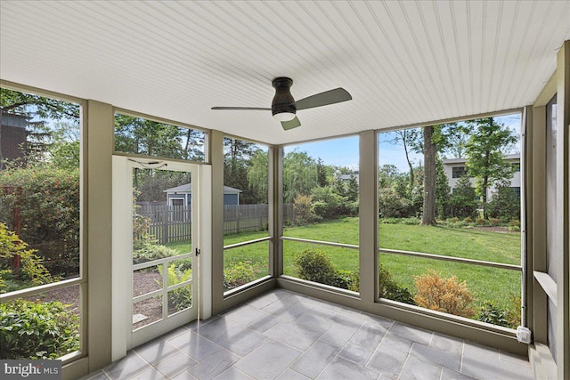 unfurnished sunroom with a ceiling fan