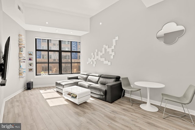 living area with baseboards, recessed lighting, wood finished floors, and visible vents