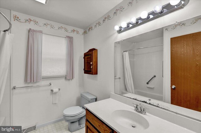 bathroom with vanity, toilet, tile patterned floors, baseboards, and visible vents